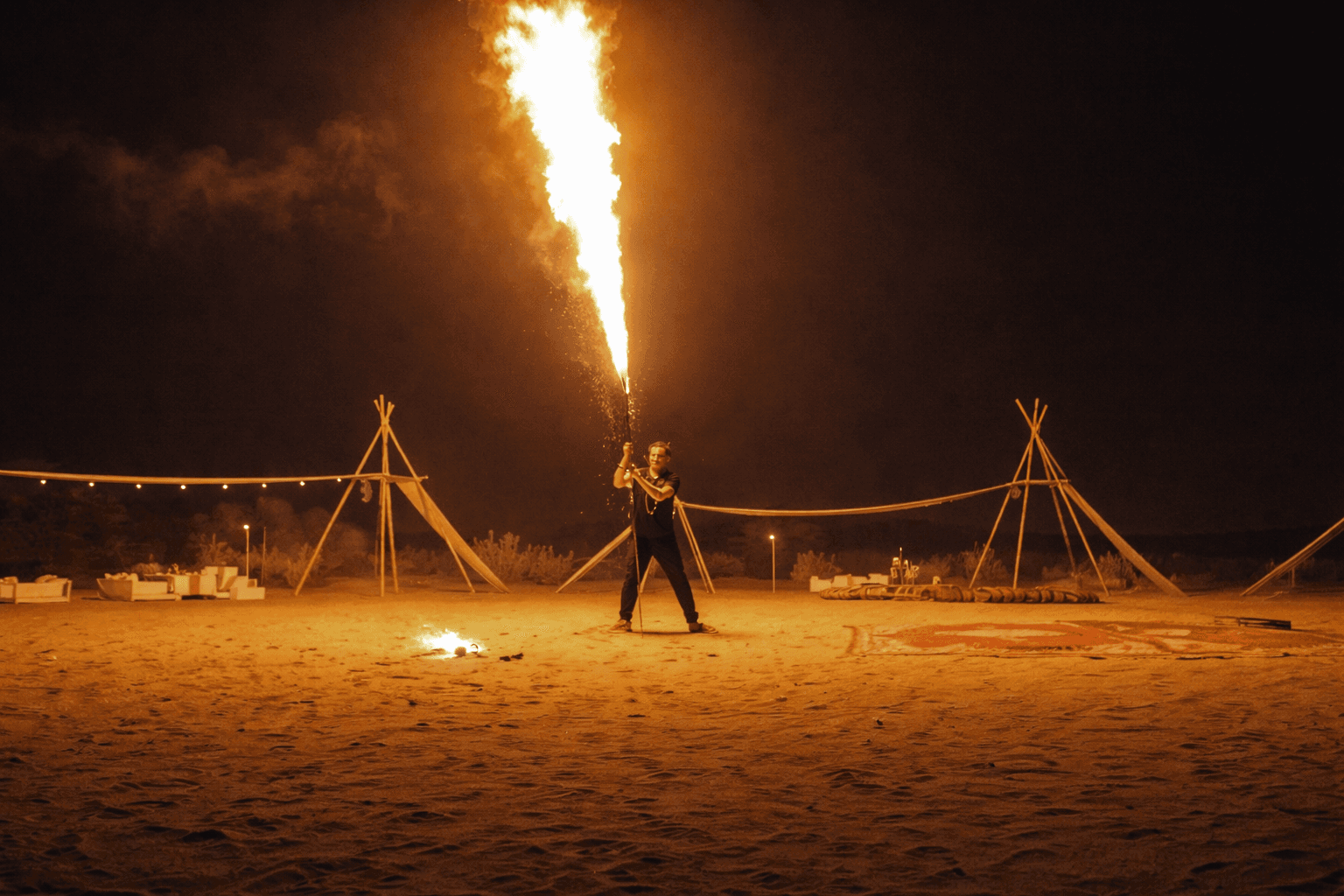 Fire show performance during desert dinner experience at Zerzura camp