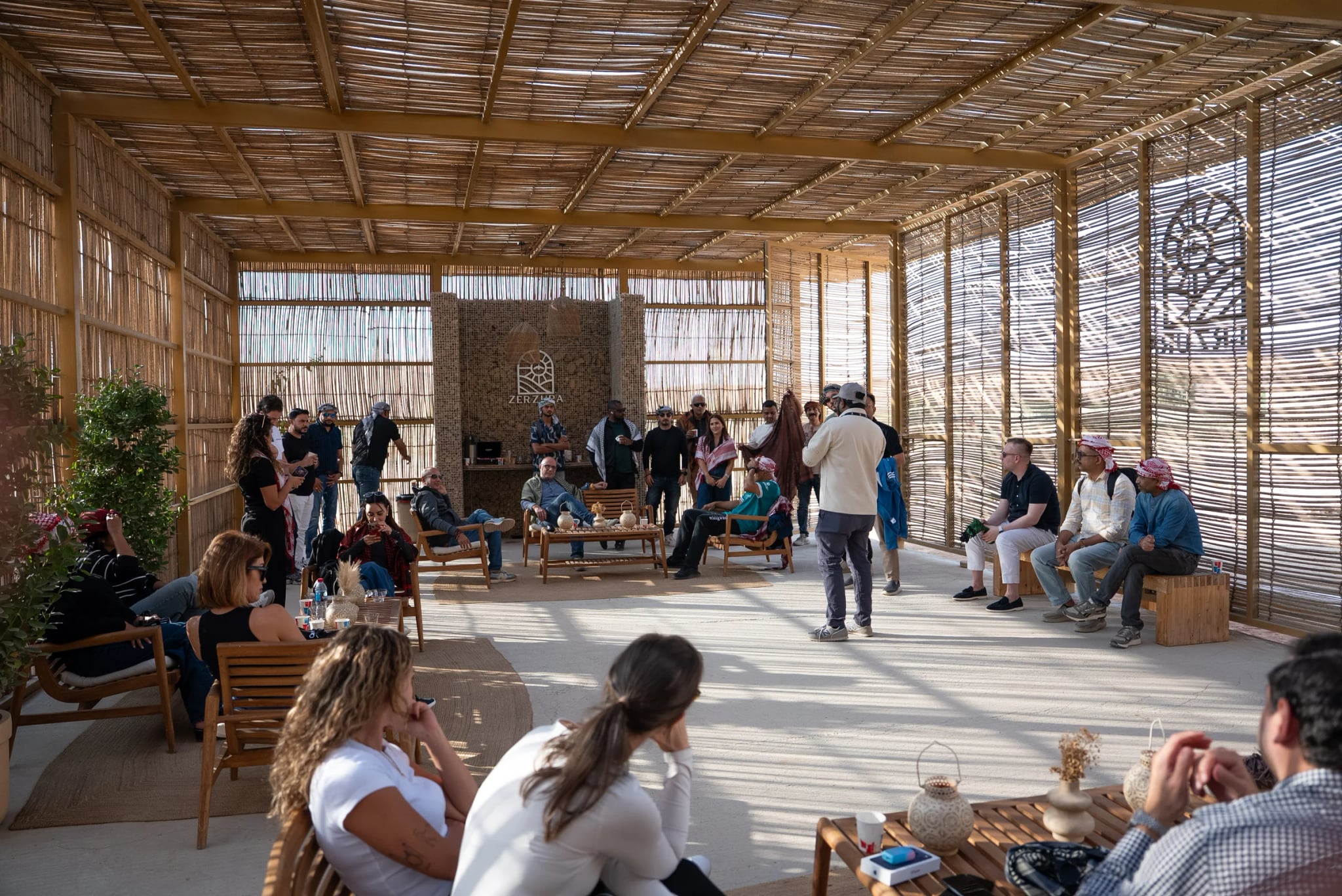 A group gathered inside the Zerzura camp pavilion