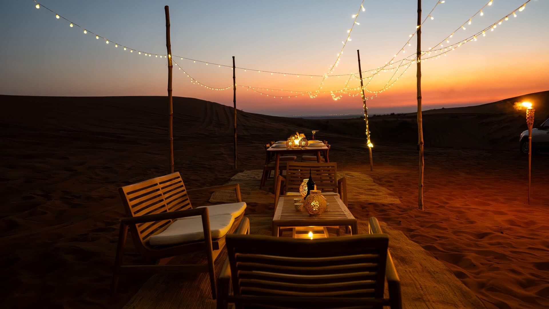 Luxury private dinner setup in the dunes at sunset in Mleiha desert
