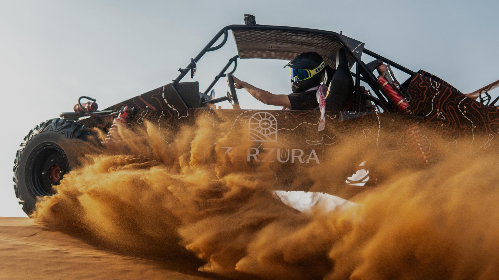 Zerzura dune buggy kicking up sand while driving through Sharjah desert