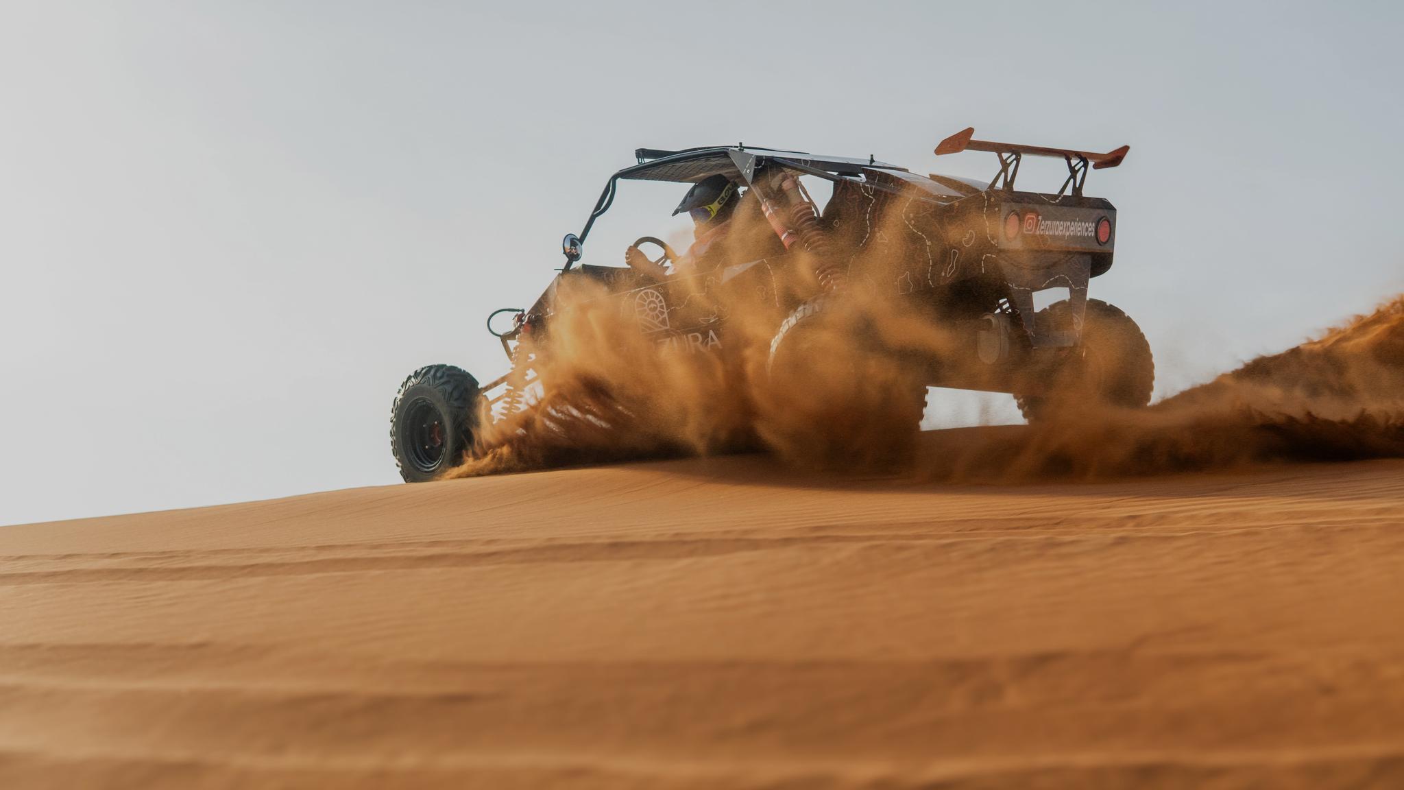 Off road dune buggy exploring Mleiha desert landscape during adventure tour