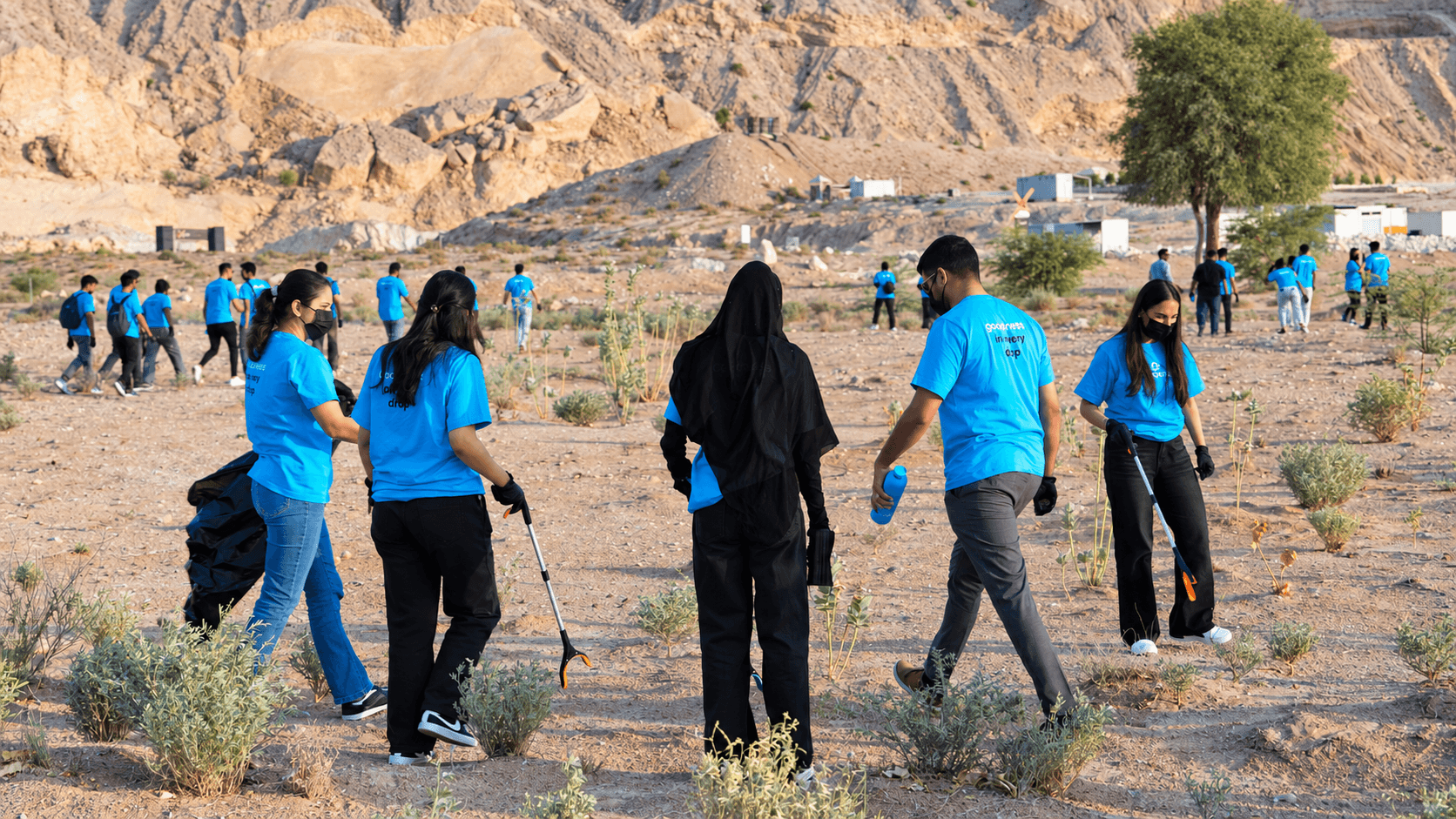 Team members collecting litter together during a desert cleanup
